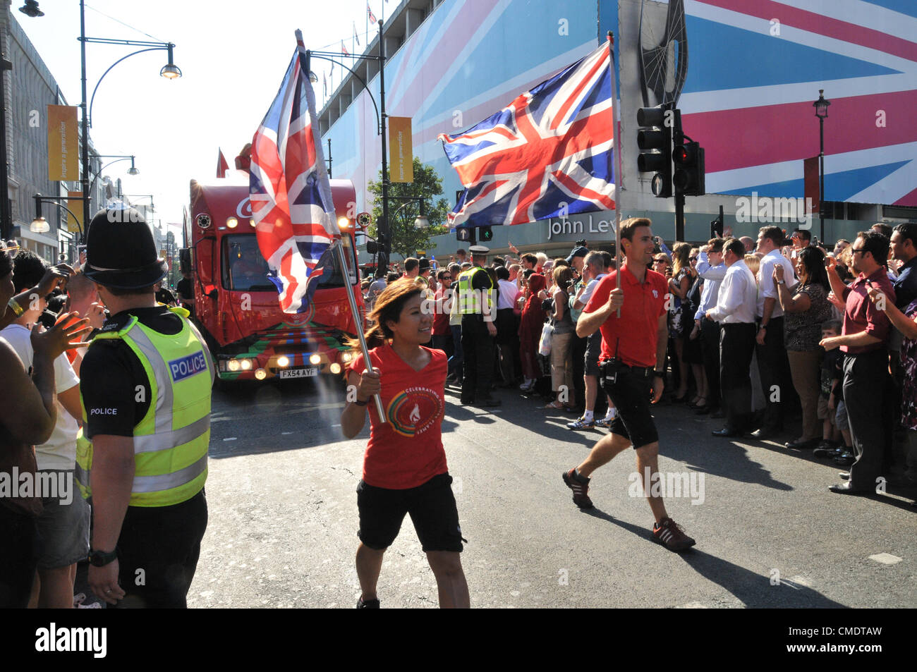 Oxford Street, London, UK. 26th July 2012. The torch relay entourage entertain the crowd as the take part in the Olympic Torch Relay as it passes along Oxford Street in central London and nears the end of its 8,000 mile journey across Britain. Stock Photo