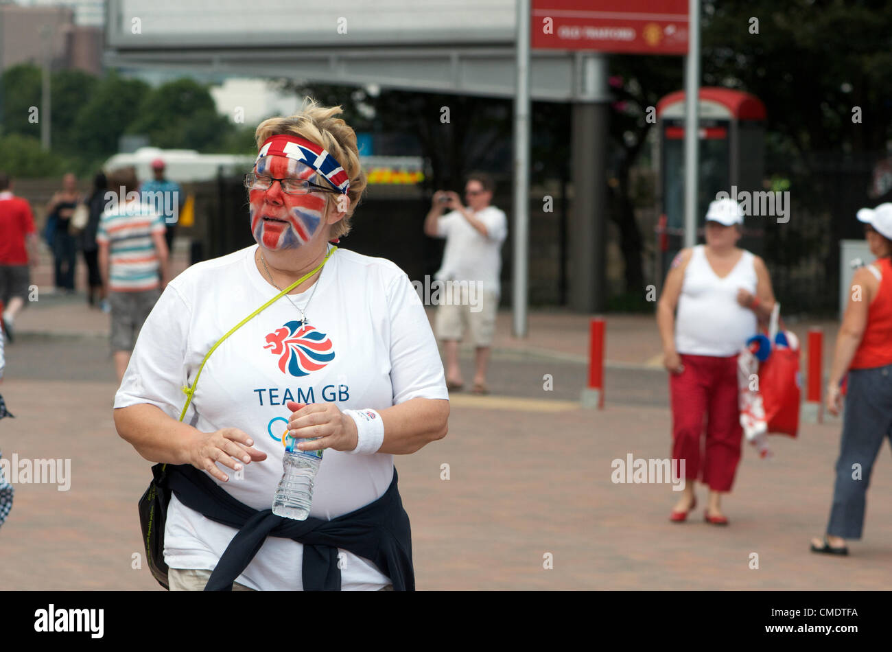 Manchester, UK. 26th July, 2012. A woman wearing a Team GB shirt and  with her face painted as the Union Flag outside Old Trafford, Manchester United's ground, where the first Olympic Football matches at the ground will be played later in the afternoon. Uruguay v United Arab Emirates will be followed by Great Britain v Senegal, 26-07-2012 Stock Photo