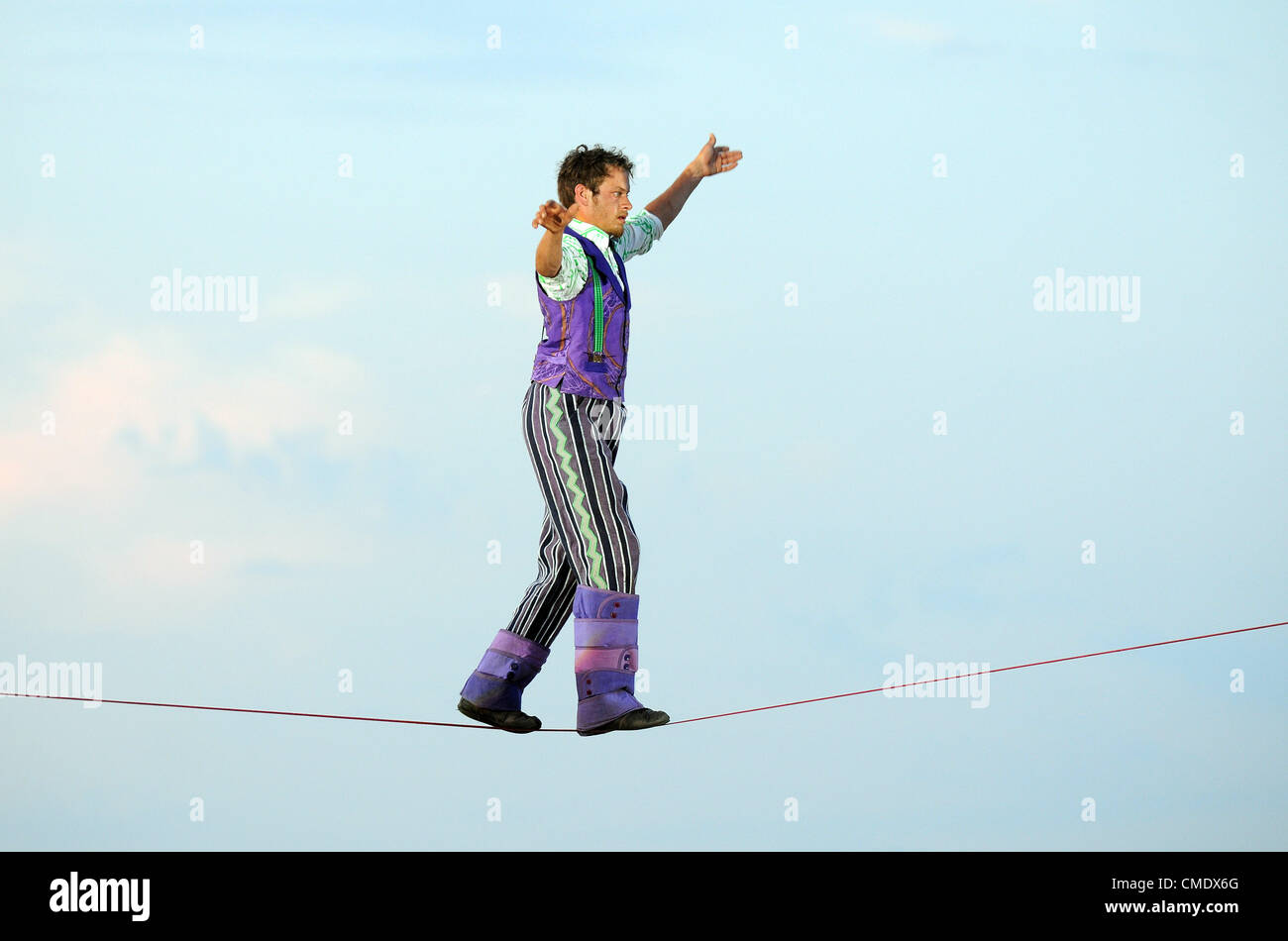 Tight rope walker. Tightrope walker. Artists Perform In The Battle Of The Winds Ahead Of The Olympic Opening Ceremony in Weymouth, Dorset, Britain, UK. Stock Photo