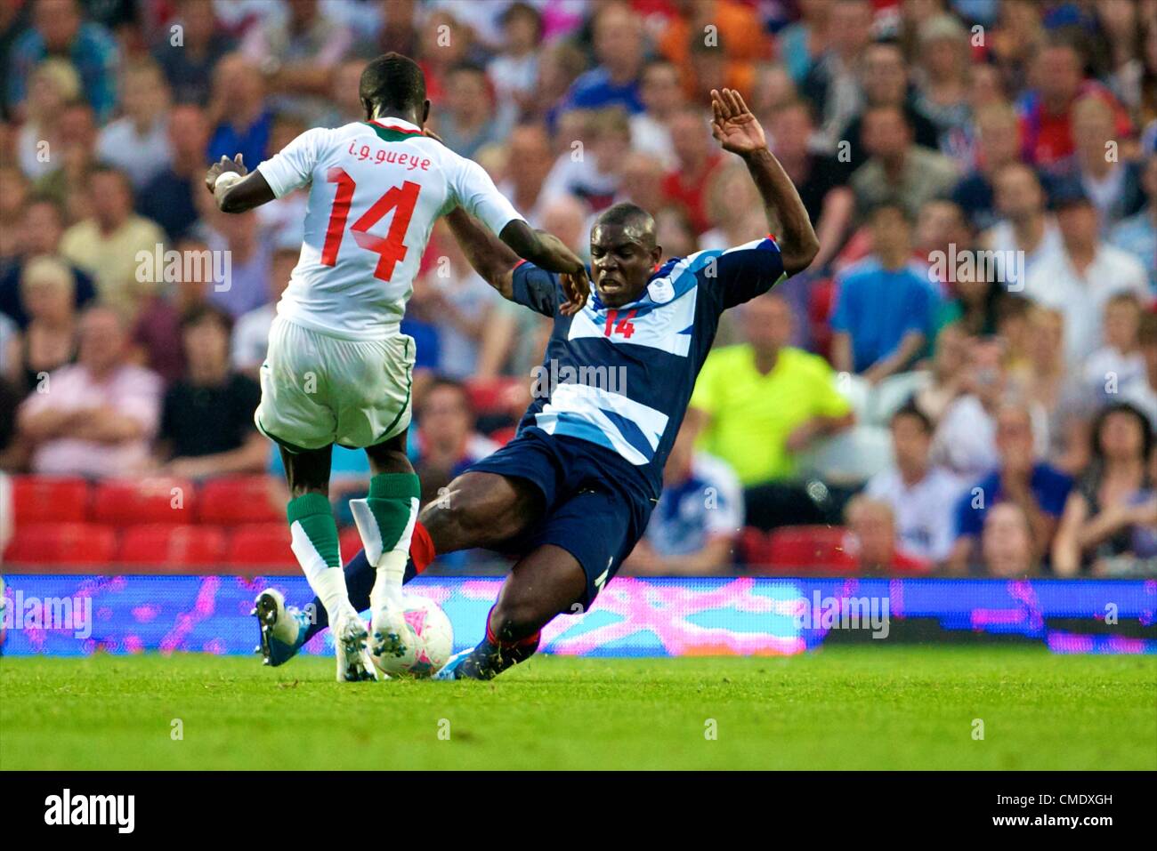 26.07.2012 Manchester, England. Senegal midfielder Idrissa Gueye and Team GB defender Micah Richards in action during the first round group A mens match between Team GB and Senegal. Stock Photo