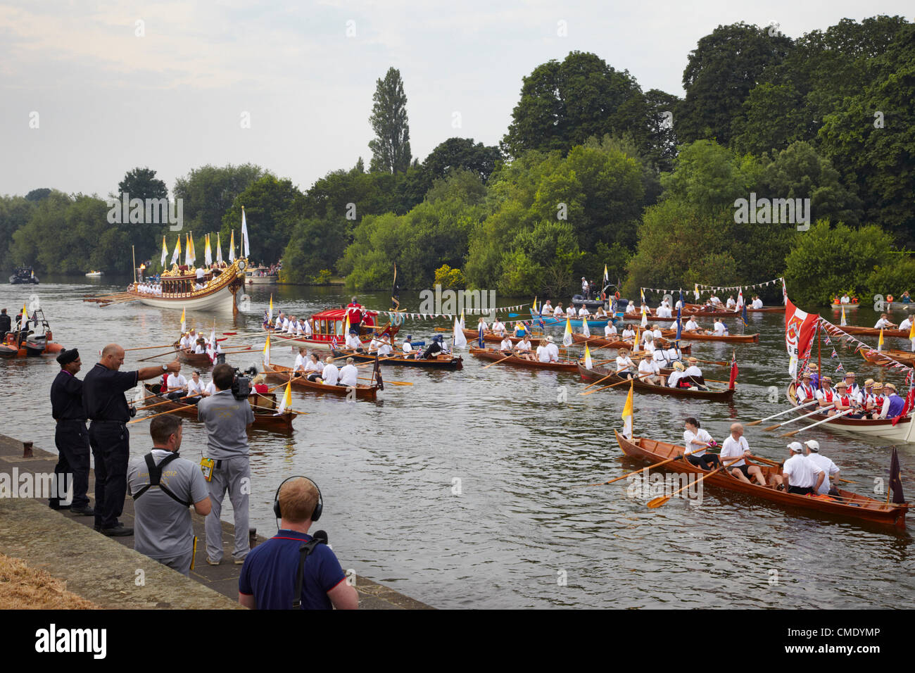 Friday 27 July, 2012. Flotilla of boats following the Gloriana rowbarge carrying the Olympic Flame on River Thames at Hampton Court on its way to London.  England. Credit:  Cephas Picture Library / Alamy Live News. Stock Photo