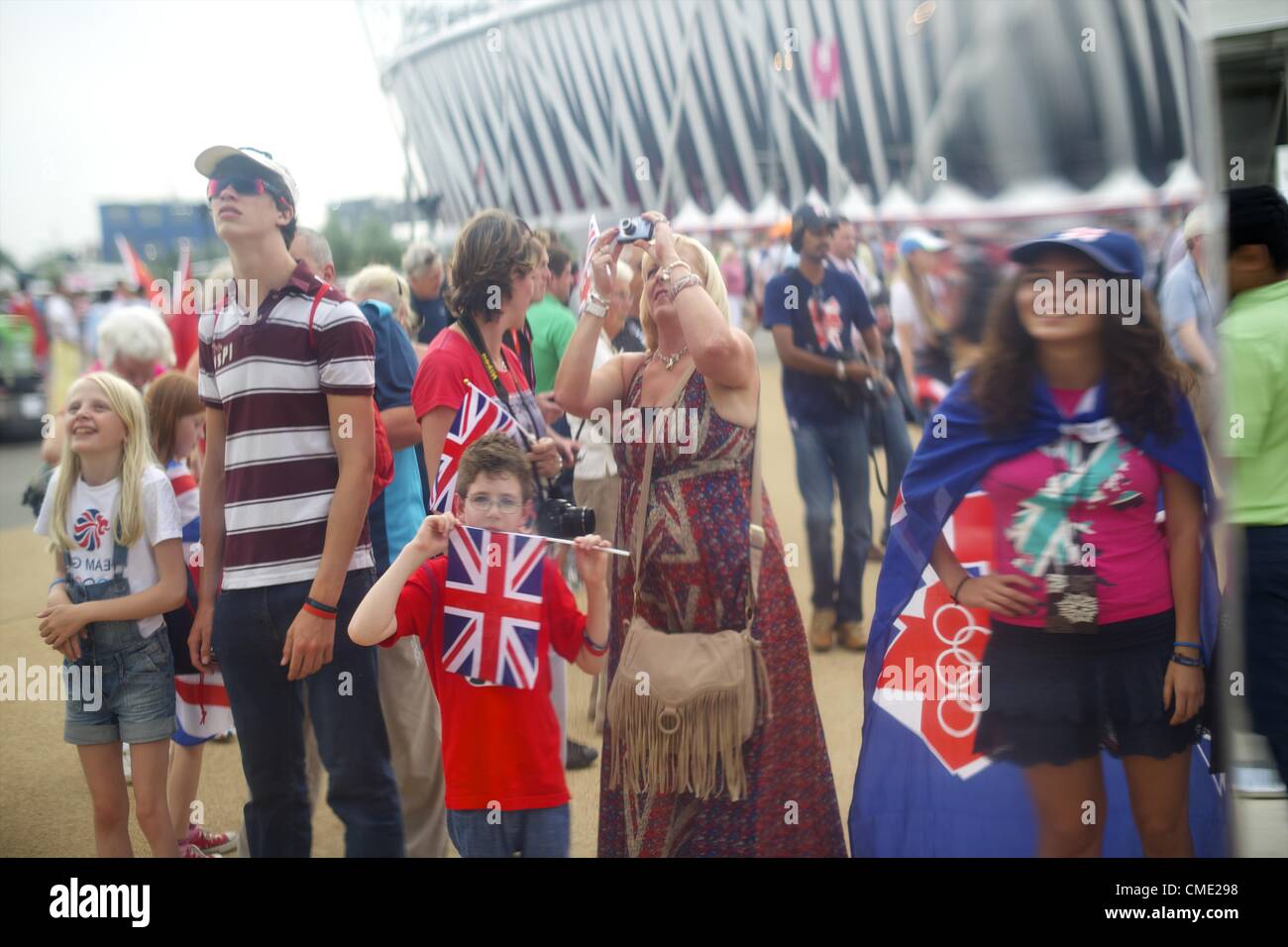 July 27, 2012 - London, England, UK - Attendees are reflected in an exhibit outside the Olympic Stadium hours before the opening ceremony of the 2012 London Summer Olympics. (Credit Image: © Mark Makela/ZUMAPRESS.com) Stock Photo