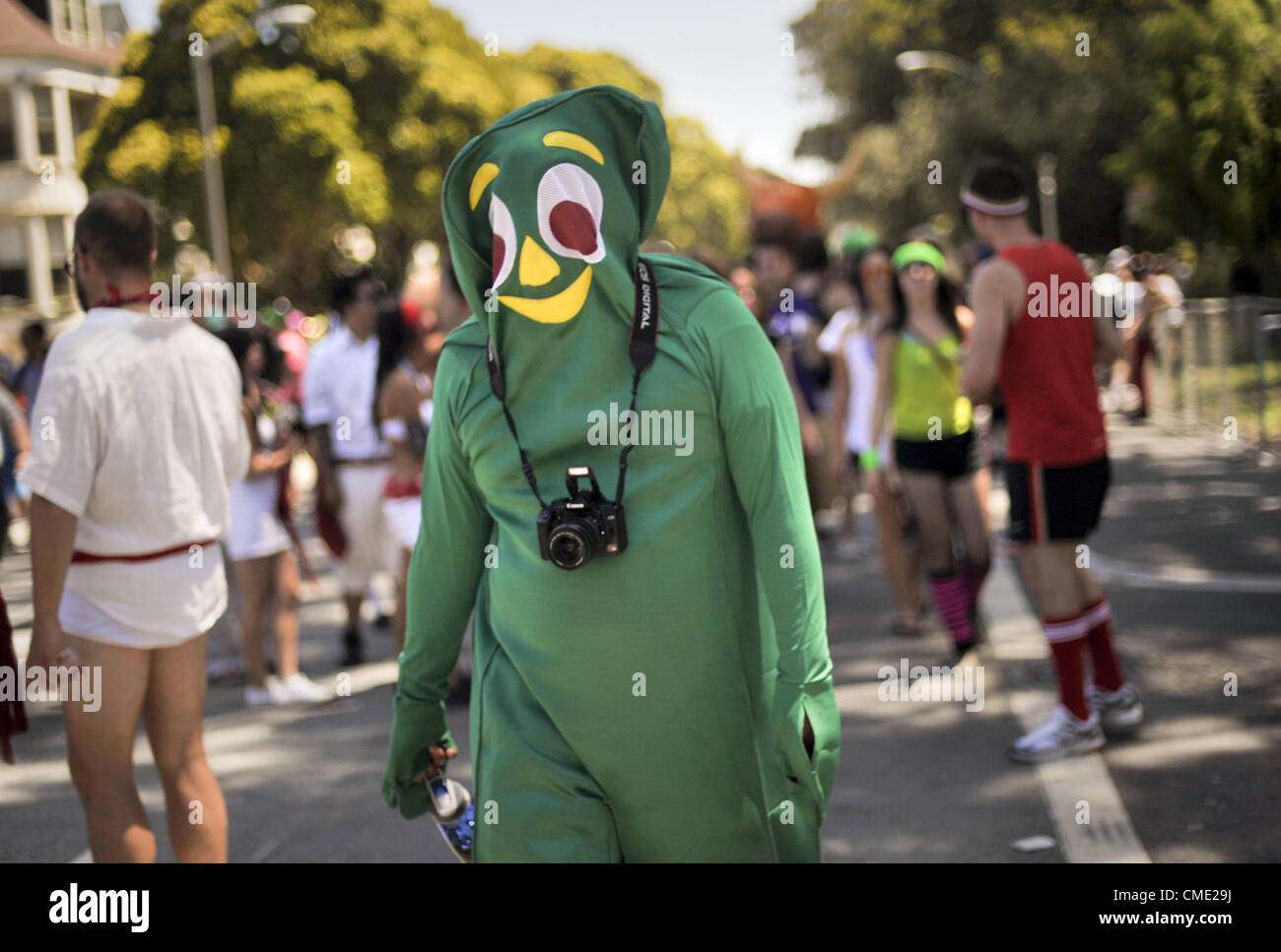 May 20, 2012 - San Francisco, California, USA - A photographer dressed in a  Gumby costume forges onward during the 103rd annual Bay to Breakers foot race in San Francisco, California on May 20, 2012. (Credit Image: © Josh Edelson/ZUMAPRESS.com) Stock Photo