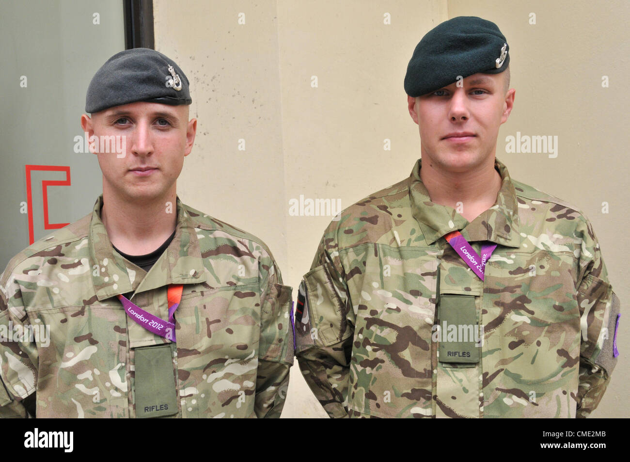 London, UK. 27th July 2012. Two soldiers pose for a portrait as the military are apparent around central London, with soldiers taking part as extra security due to the poor performance of G4S the private security firm. Stock Photo