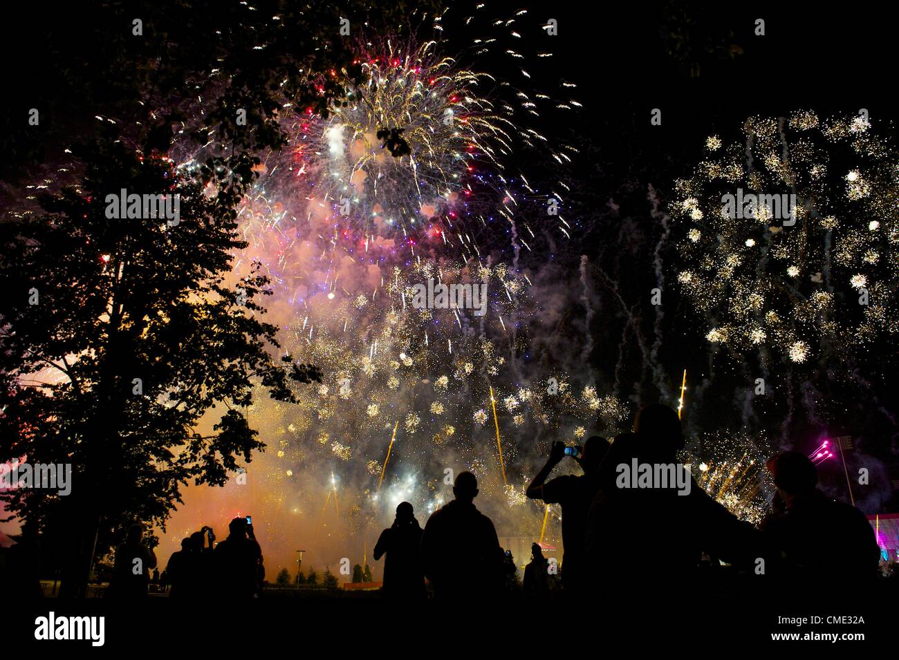 July 27, 2012 - London, England, UK - Dancers who performed in the 2012 London Summer Olympics observe a fireworks display outside the Olympic Stadium. (Credit Image: © Mark Makela/ZUMAPRESS.com) Stock Photo
