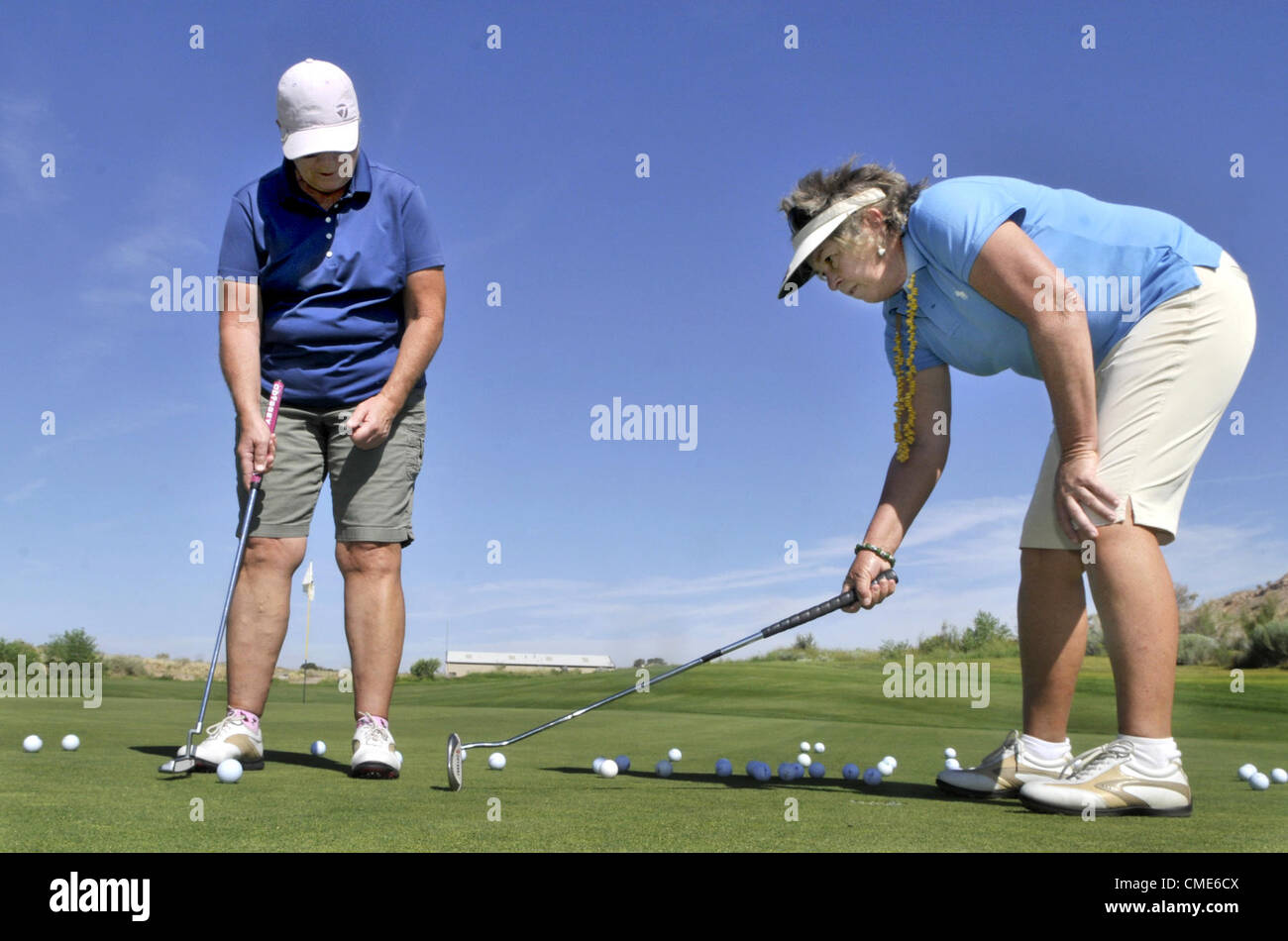 July 28, 2012 - Santa Ana Pueblo, NM, U.S. - Greg Sorber --  LPGA Hall of Fame golfer Hollis Stacey, right,  gives putting tips to M.J. Maxfield of Albuquerque during a golf clinic at the Twin Warriors Golf Course on Saturday, July 28, 2012. (Credit Image: © Greg Sorber/Albuquerque Journal/ZUMAPRESS.com) Stock Photo