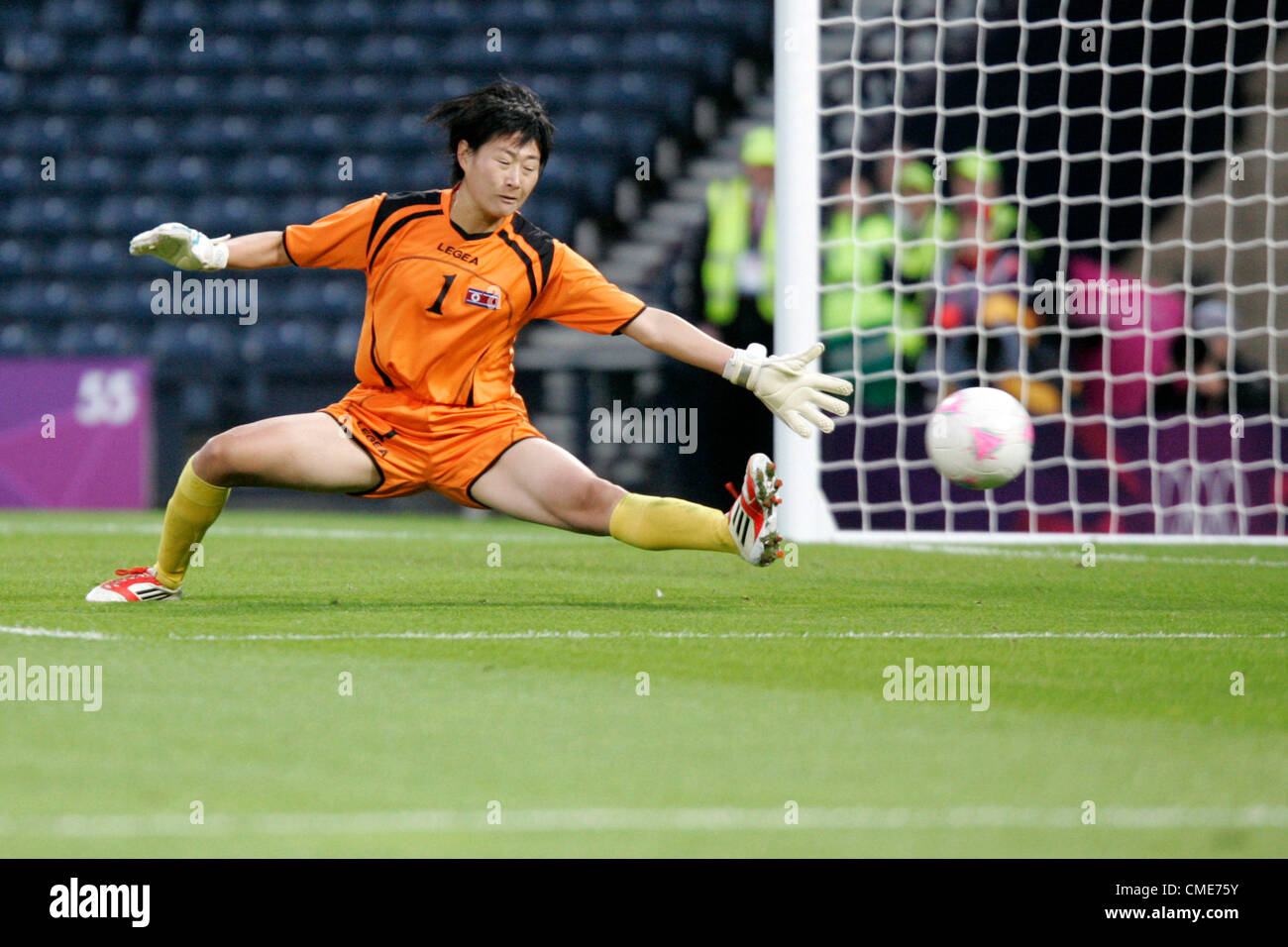 28.07.2012 Glasgow, Scotland. France score a second goal past goalkeeper Jo Yun-Mi of N Korea  during the Olympic Football women's Preliminary game between France and Korea from Hampden Park. Stock Photo