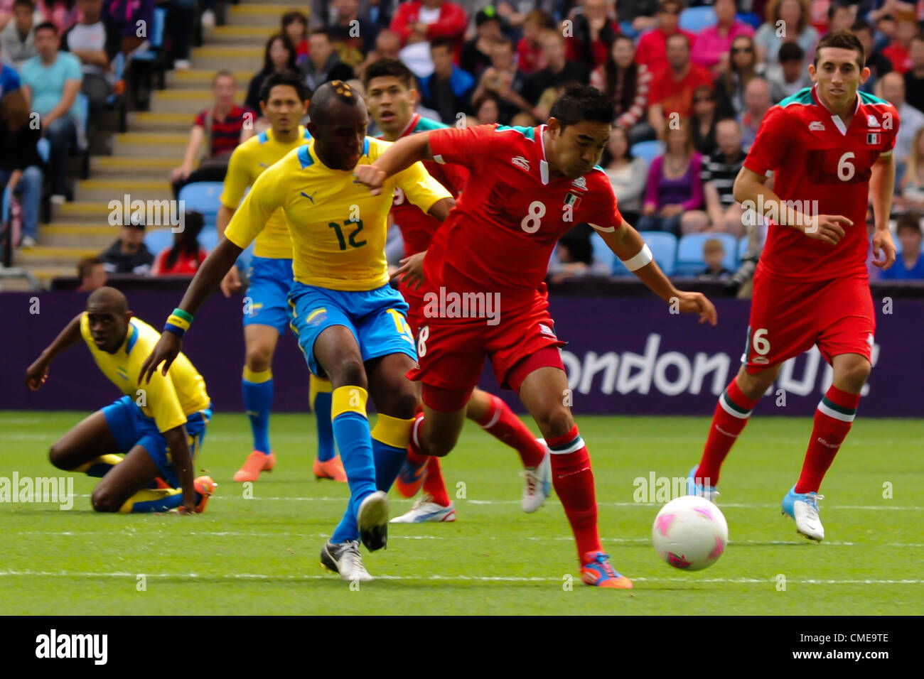 29.07.2012 Coventry, England. Marco FABIAN (Mexico) and Merlin TANDJIGORA (Gabon) in action during the Olympic Football Men's Preliminary game between Mexico and Gabon from the City of Coventry Stadium Stock Photo