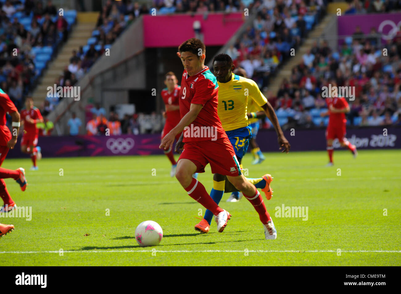 29.07.2012 Coventry, England. Oribe PERALTA (Mexico) and Mabikou BOUSSOUGHOU (Gabon) in action during the Olympic Football Men's Preliminary game between Mexico and Gabon from the City of Coventry Stadium Stock Photo