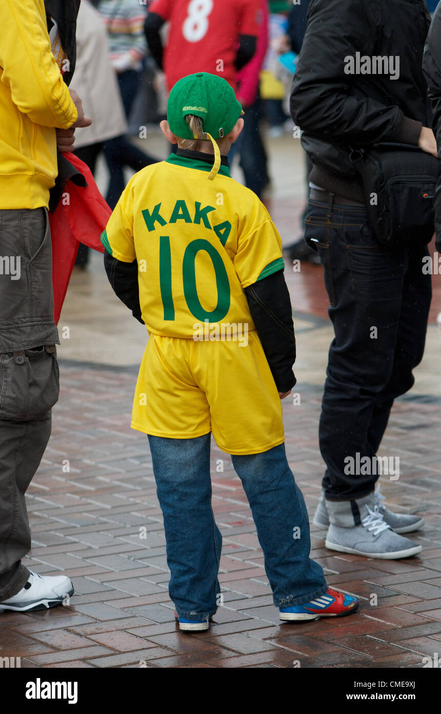 A young Brazilian fan wearing the shirt of Kaka, a Brazilian star player, stands outside Old Trafford, Manchester United's ground, where Olympic Football matches  will be played later in the afternoon.Brazil v Belarus will be followed by Egypt v New Zealand. Manchester, UK 29-07-2012 Stock Photo