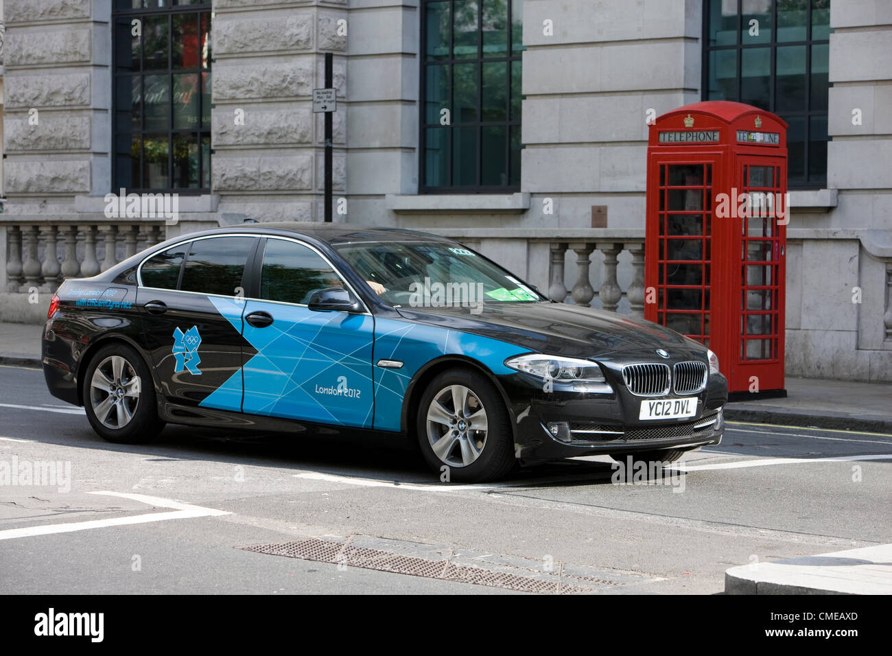 LONDON 28 July 0212. An official Olympic vehicle parked next to a London red telephone box. London 2012. Stock Photo
