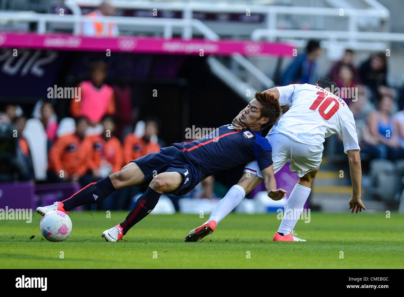 29.07.2012 Newcastle, England. Abdelaziz Barrada of Morocco drags Japan's Hotaru Yamaguchi by the neck in action during the Olympic Football Men's Preliminary game between Japan and Morocco from St James Park. Stock Photo
