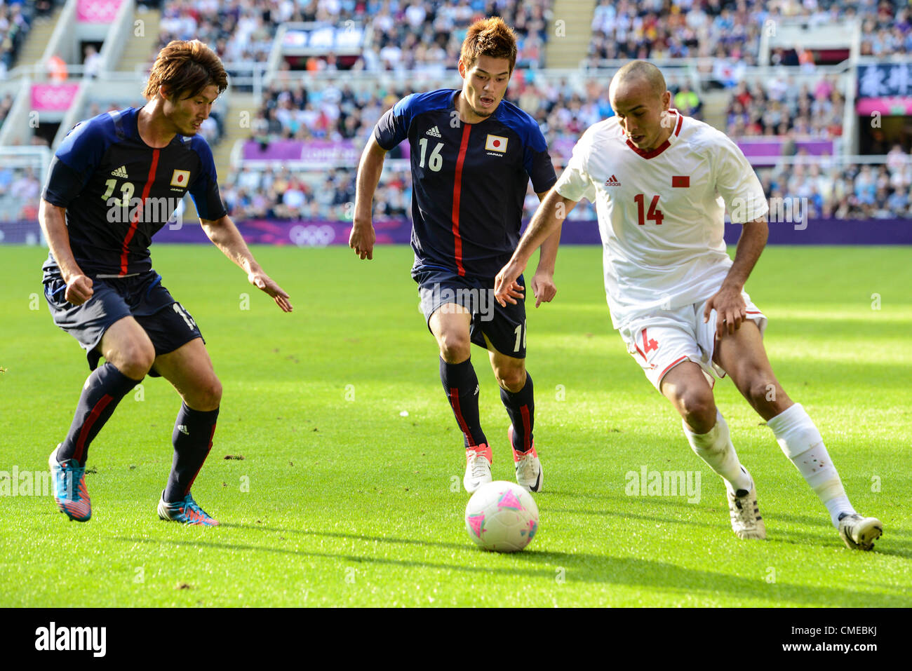 29.07.2012 Newcastle, England. Morocco's Houssine Kharja takes on Daisuke Suzuki and Hotaru Yamaguchi in action during the Olympic Football Men's Preliminary game between Japan and Morocco from St James Park. Stock Photo