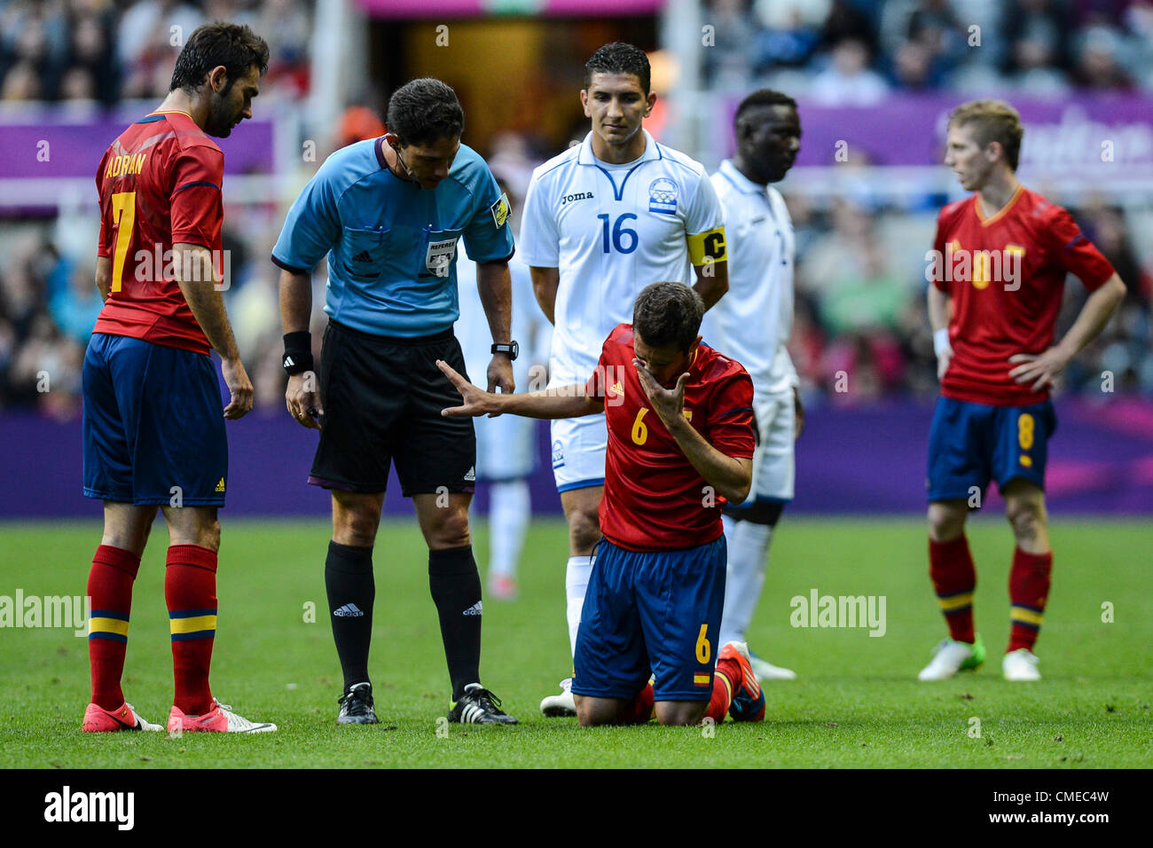 29.07.2012 Newcastle, England. Jordi Alba holds his throat after a rough tackle from Luis Garrido during the Olympic Football Men's Preliminary game between Spain and Honduras from St James Park. Stock Photo