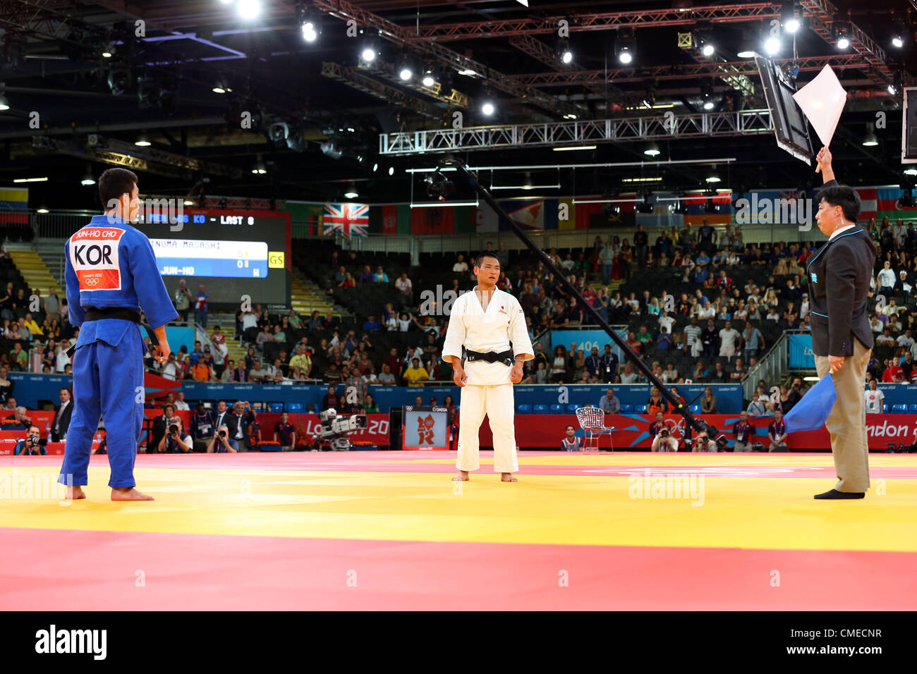 (L to R) Cho Jun Ho (KOR), Masashi Ebinuma (JPN),  JULY 29, 2012 - Judo :  Men's -66kg Quarter-final  at ExCeL  during the London 2012 Olympic Games The match ended with bizarre scenes as originally the three judges on the mat all rose blue flags to designate Cho as the winner. This resulted in booing from the crowd and the International Judo Federation's Refeering Commission called over the three judges to speak with them. They then returned to the mat and all three raised white flags to designate Ebinuma as the winner. Both judokas later ended up taking the two bronze medals available in the Stock Photo