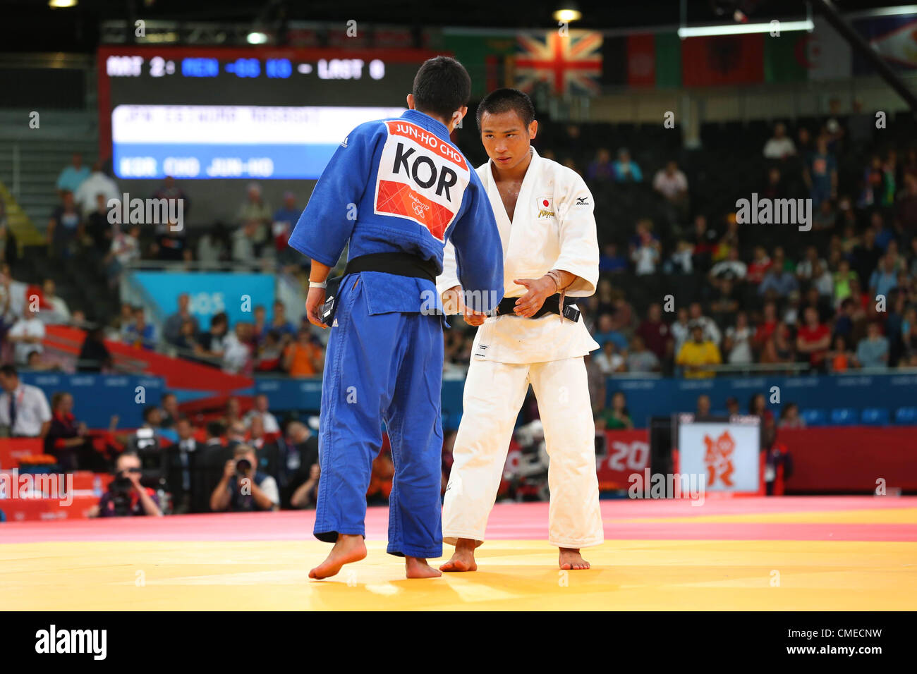 (L to R) Cho Jun Ho (KOR), Masashi Ebinuma (JPN),  JULY 29, 2012 - Judo :  Men's -66kg Quarter-final  at ExCeL  during the London 2012 Olympic Games The match ended with bizarre scenes as originally the three judges on the mat all rose blue flags to designate Cho as the winner. This resulted in booing from the crowd and the International Judo Federation's Refeering Commission called over the three judges to speak with them. They then returned to the mat and all three raised white flags to designate Ebinuma as the winner. Both judokas later ended up taking the two bronze medals available in the Stock Photo