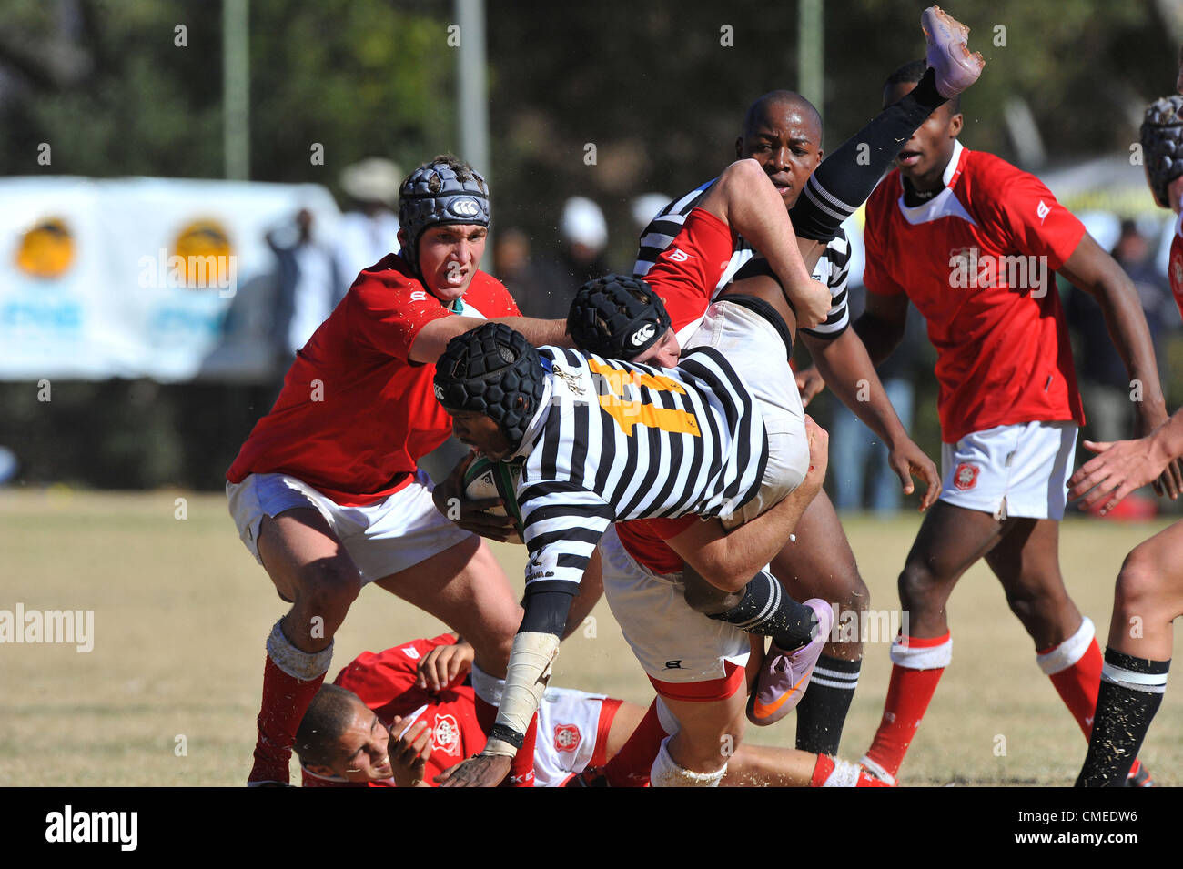 JOHANNESBURG, SOUTH AFRICA - JULY 28, Sibusiso Kunene of Jeppe tackled during the FNB Classic Clashes match between Jeppe (Black/White) and KES (Red/White)from Jeppe Boys High on July 28, 2012 in Johannesburg, South Africa Photo by Duif du Toit / Gallo Images Stock Photo