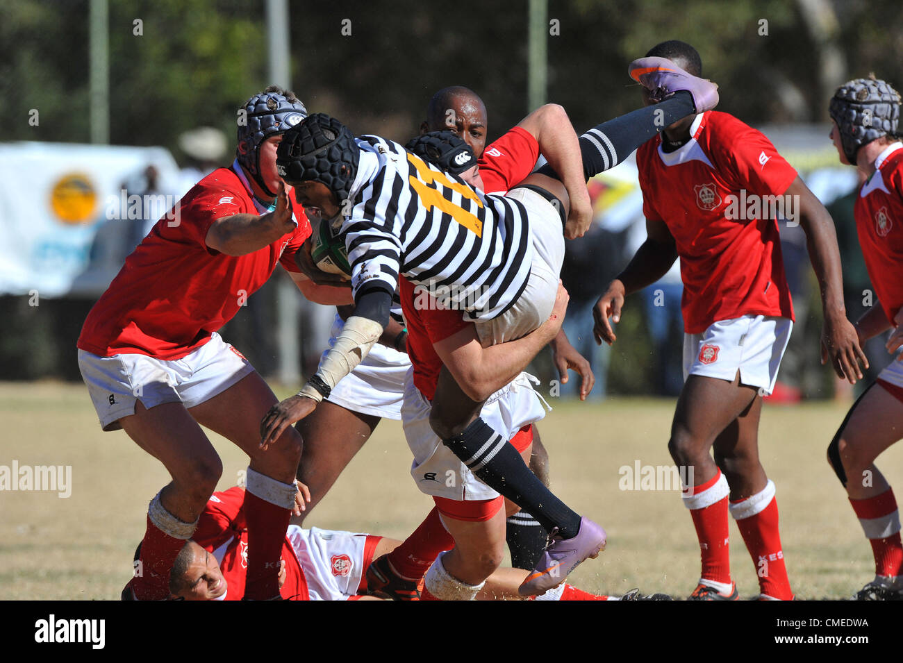 JOHANNESBURG, SOUTH AFRICA - JULY 28, Sibusiso Kunene of Jeppe tackled during the FNB Classic Clashes match between Jeppe (Black/White) and KES (Red/White)from Jeppe Boys High on July 28, 2012 in Johannesburg, South Africa Photo by Duif du Toit / Gallo Images Stock Photo