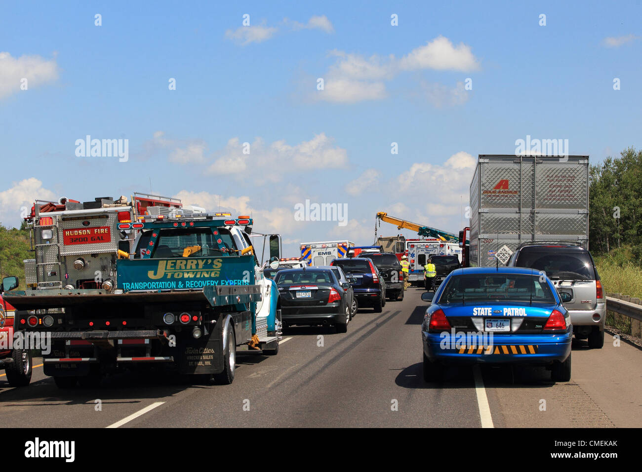 Monday, 30 July, 2012 -- Emergency workers try to free the driver of a Sport Utility Vehicle which crashed into the rear of a flatbed semi-trailer on I-94 near mile marker 6 in Hudson, Wisconsin, USA. At least one person died in the accident. Stock Photo