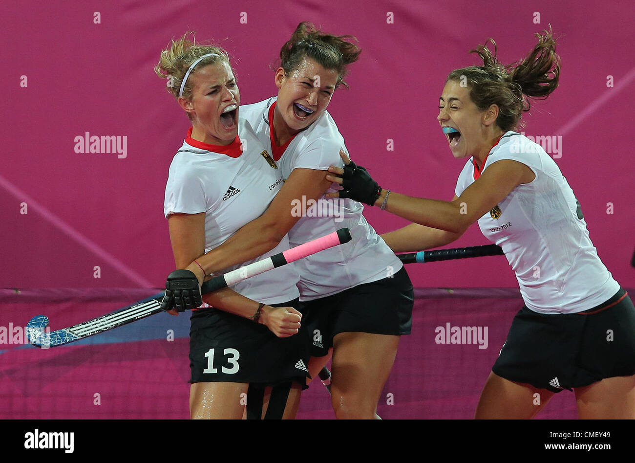 31.07.2012. London England. Germany's Katharina Otte (L) celebrates her goal with team mates Julia Mueller (M) and Marie Maevers during women's field hockey preliminary round match against Australia at Olympic Park Riverbank Arena for the London 2012 Olympic Games, London, Britain, 31 July 2012. Stock Photo