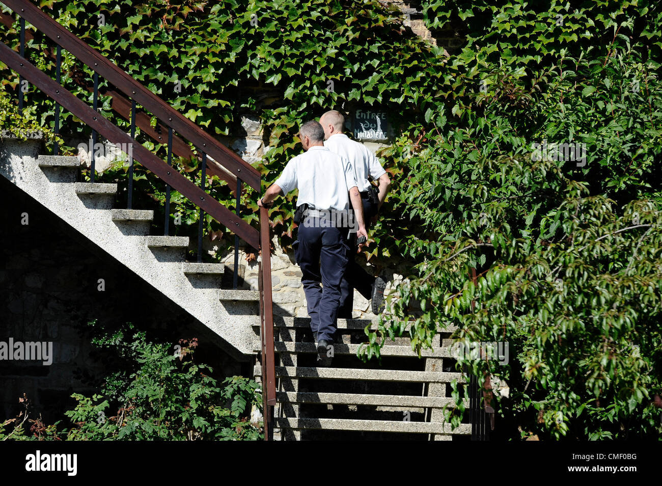 Aug. 1, 2012 - Brussels, Bxl, Belgium - Policeman is looking at  the Graffitis on the wall of the ''Poor Clares'' Clarisse Convent in Malonne, a village 60 km (37 miles) southeast of  Brussels, Belgium on 01.08.2012 Michelle Martin, the ex-wife and accomplice of Marc Dutroux, the convicted child murderer whose crimes horrified and shocked Belgium in the mid-1990s, is to be released from prison and sent to a convent, a court ruled on Tuesday. The court ruled that Martin, who was not in court, could go to the Clarisse Convent in Malonne. Unknown assailants,  write on the wall of the monastery 'N Stock Photo