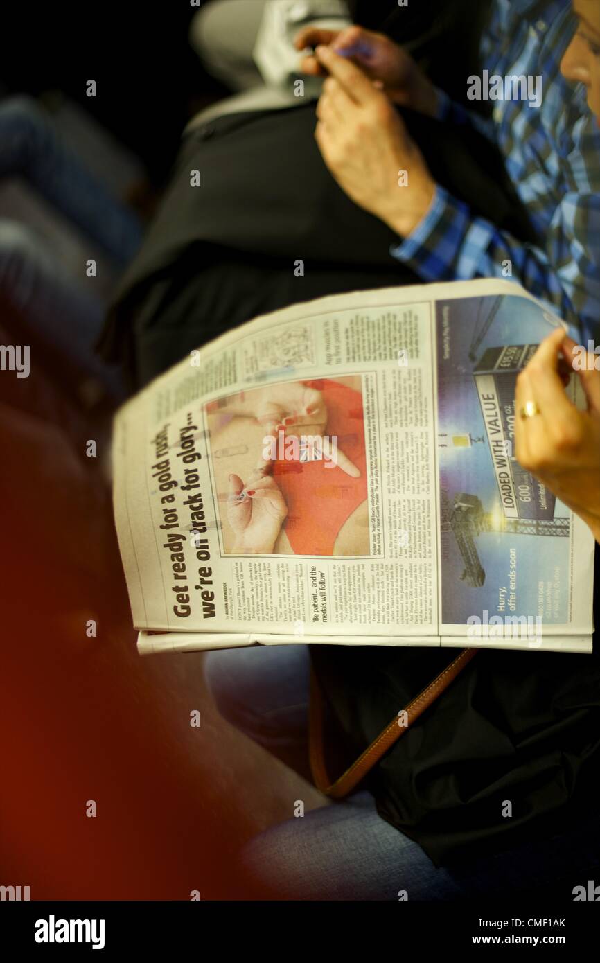 Aug. 1, 2012 - London, England, United Kingdom - A woman reads newspaper articles featuring the Olympics on the sixth day of the 2012 London Summer Olympiad. (Credit Image: © Mark Makela/ZUMAPRESS.com) Stock Photo