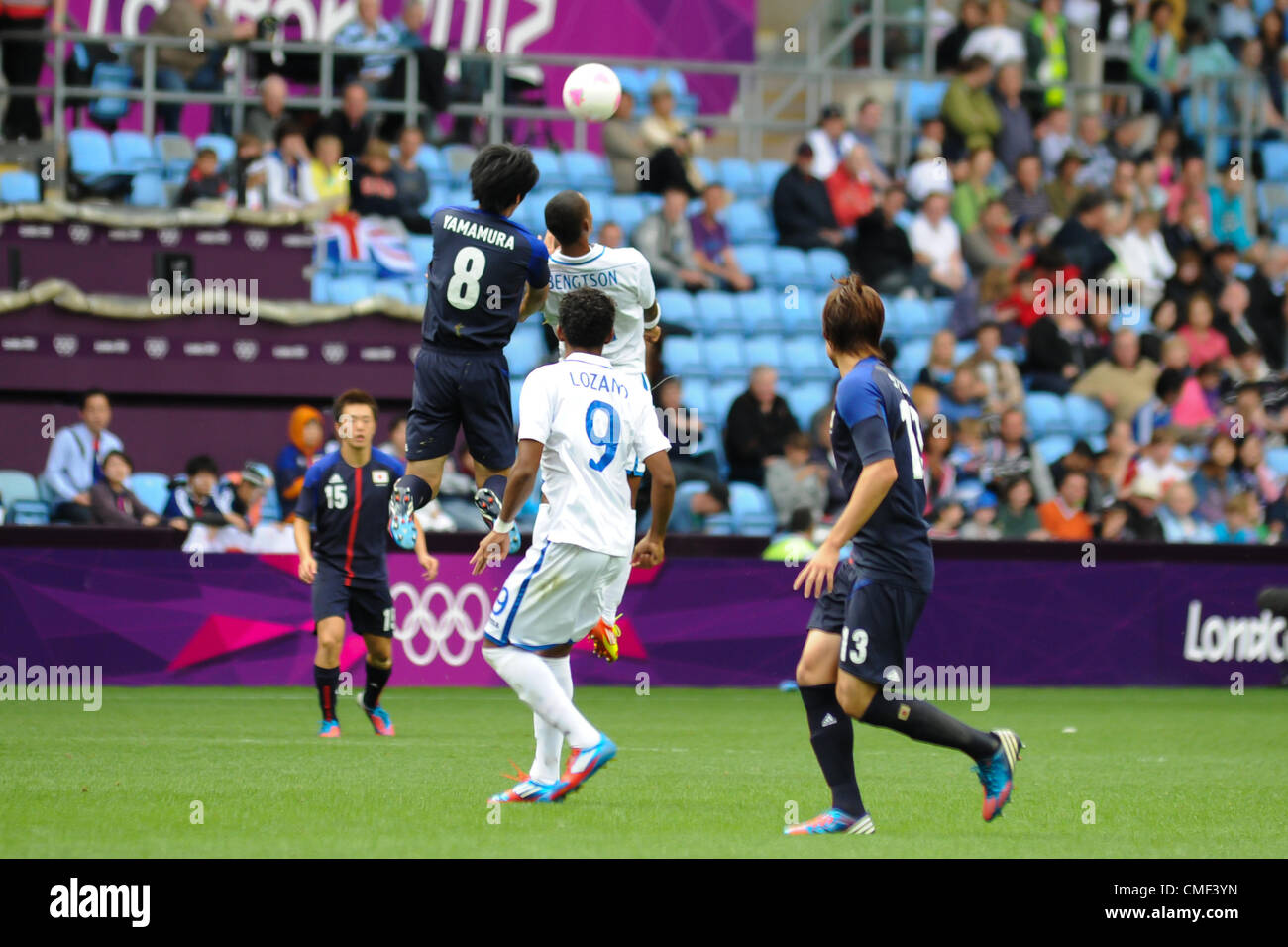 01.08.2012 Coventry, England. Kazuya YAMAMURA (Japan) and Jerry BENGTSON (Honduras) in action during the Olympic Football Men's Preliminary game between Japan and Honduras from the City of Coventry Stadium Stock Photo