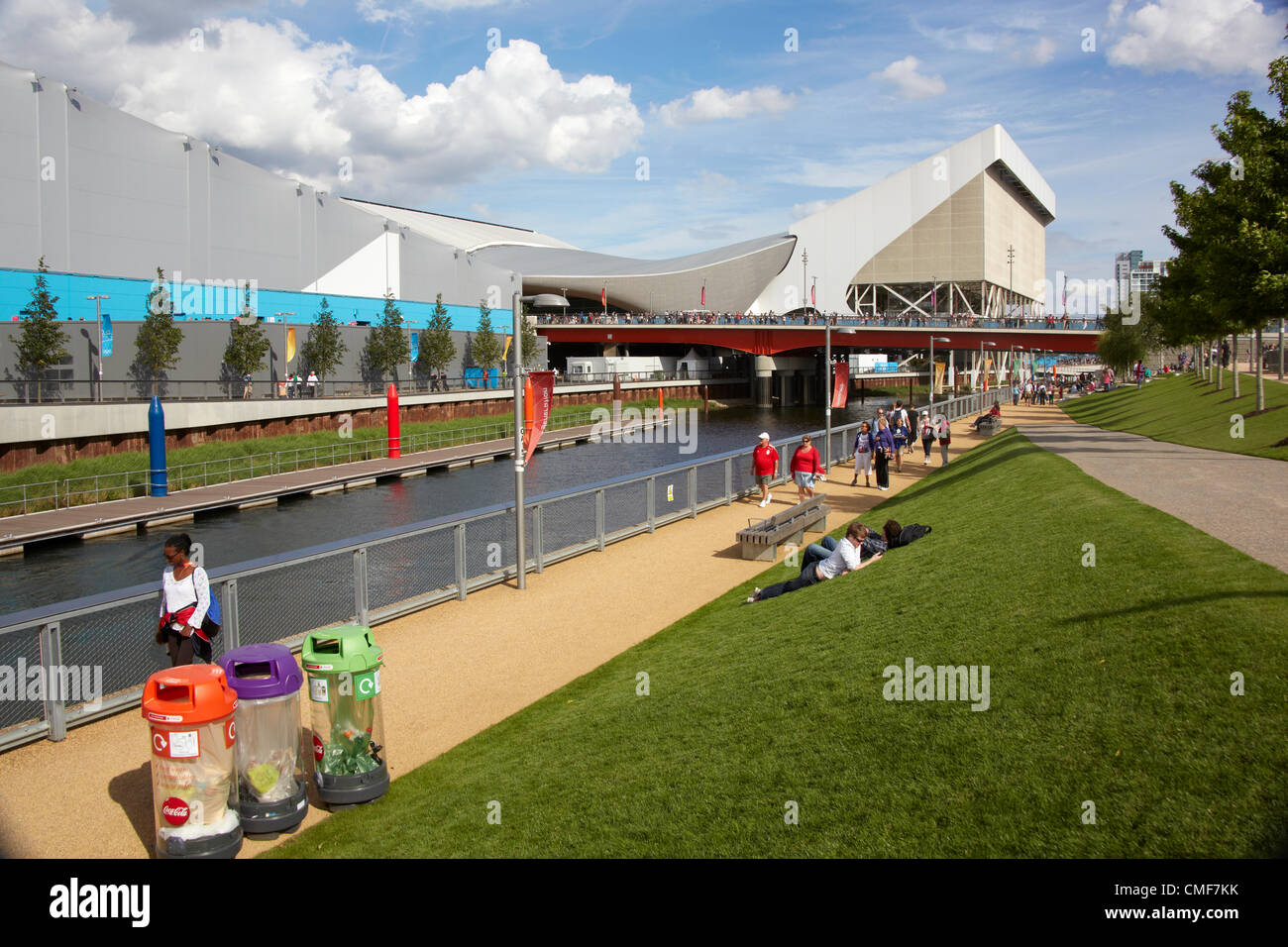 Aquatics Centre and River Lea with people on a sunny day at Olympic Park, London 2012 Olympic Games site, Stratford London E20 UK, Stock Photo