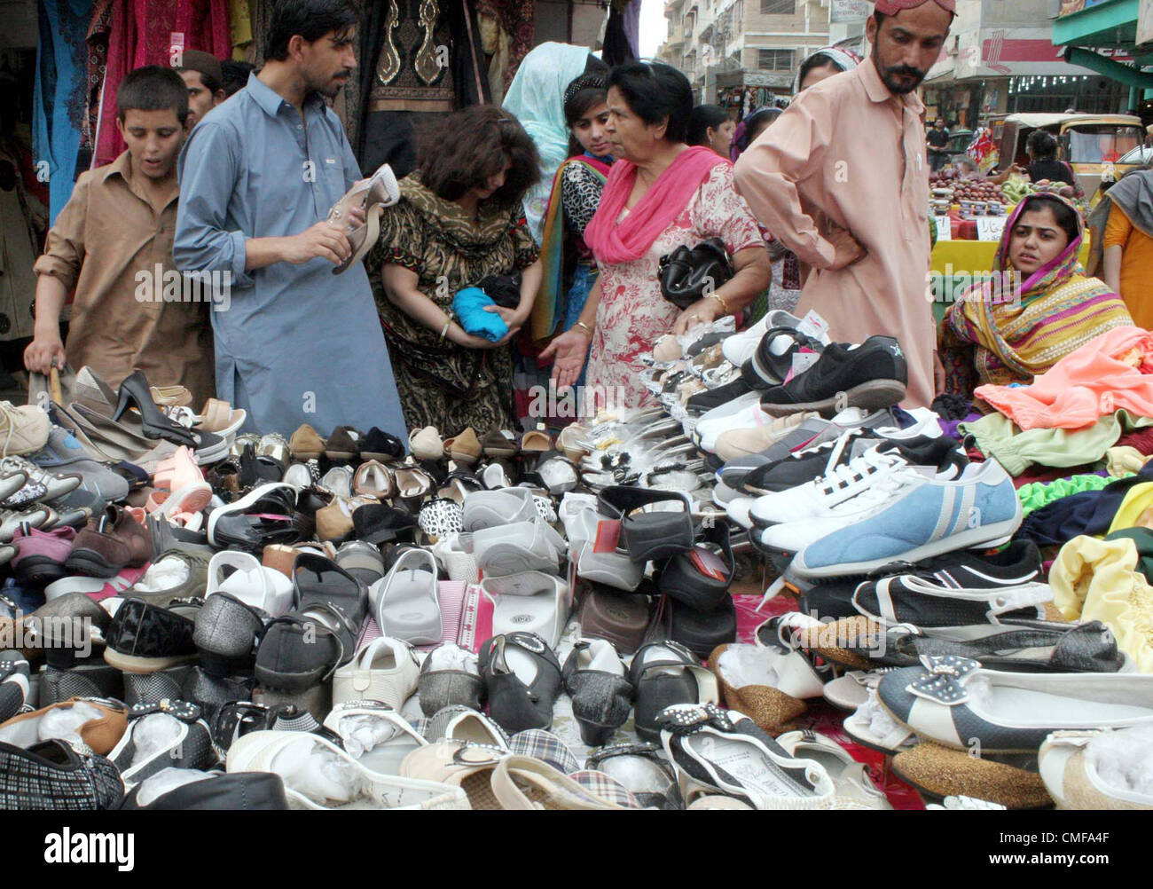 People busy to buy shoes at a shop at Tariq road market during the Holy