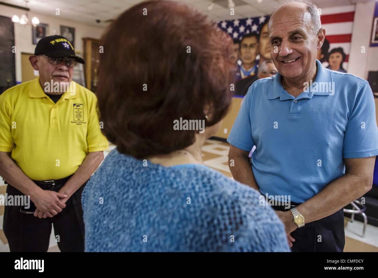 Aug. 2, 2012 - Phoenix, Arizona, U.S - Dr RICHARD CARMONA (blue shirt) talks to a veteran who was an Air Force nurse in Vietnam during a campaign stop at an American Legion Hall in Phoenix Thursday. Carmona, the former US Surgeon General under President George W. Bush, is running for the US Senate as a Democrat. Carmona's personal story is an important part of his campaign. He dropped out of high school to join the US Army. He applied for Special Forces and was turned down because he didn't have a high school diploma, he got his GED, reapplied and was accepted into Special Forces. He served in Stock Photo