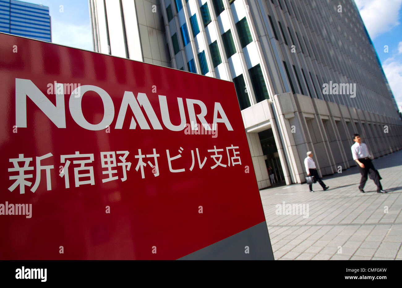 August 3, 2012 Tokyo, Japan Businessmen walk out the the Nomura Holdings Inc. building in
