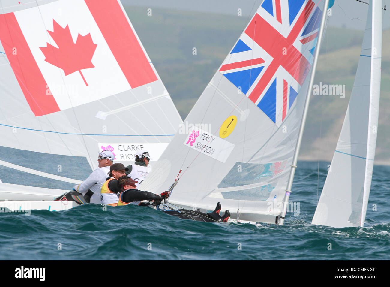 03.08.2012. Weymouth, England. Olympic Games Sailing at Weymouth, Dorset, August 2012. Olympic gold medalists (2008 Games) Iain Percy and Andrew Simpson for Team GB come close to a collission with Canada boat in the Star class out on Weymouth bay. Stock Photo