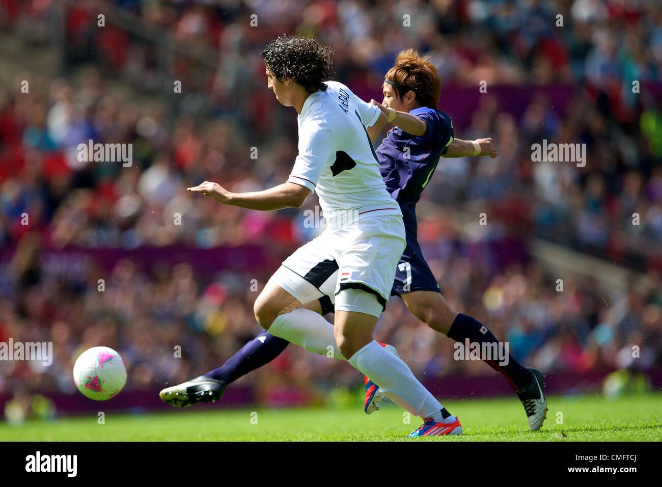 UK. 04.08.2012 Manchester, England. Japan forward Yuki Otsu and Egypt defender Ahmed Hegazy in action during the quarter final match between Japan and Egypt at Old Trafford. Japan won the game by a score of 3-0 to proceed to the tournament semi-finals. Stock Photo