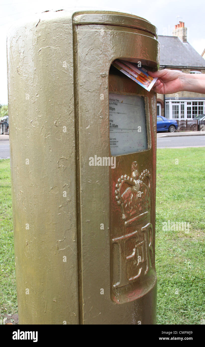 Stotfold, Bedfordshire, England - To mark Victoria Pendleton's Olympic Gold medal performance in winning the Women's Cycling Keirin, Royal Mail has painted a post box in her hometown of Stotfold, Bedfordshire, gold. In addition, to celebrate Team GB's 8th Gold Medal at the London 2012 Olympics, another stamp in Royal Mail's Gold Collection has been produced. The stamps will be on sale in over 500 Post Office branches across the UK  -  August 4th 2012  Photo by Keith Mayhew Stock Photo