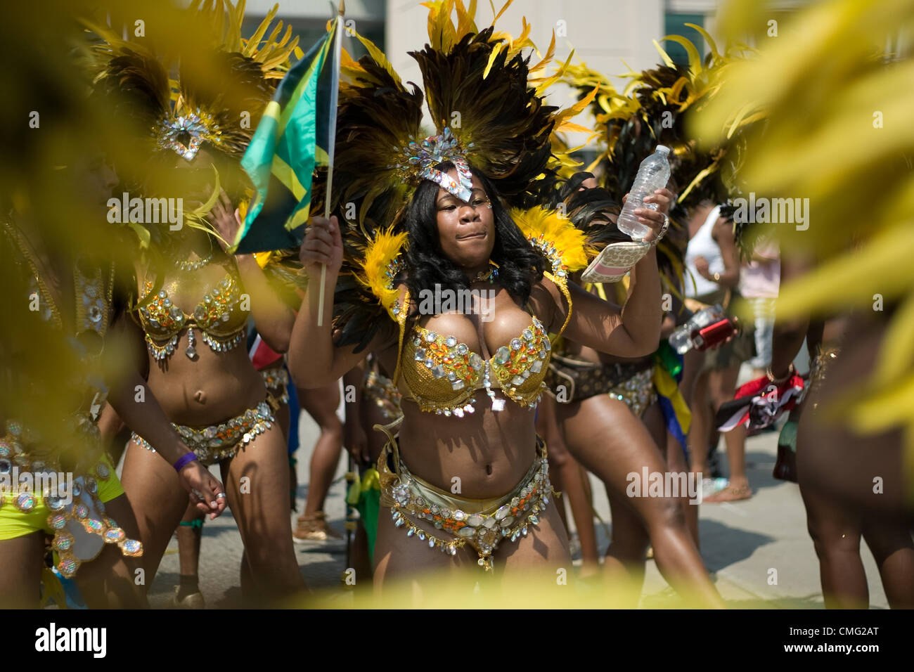 Toronto Ontario, Canada - August 4, 2012. The 47th annual Toronto Caribbean Carnival parade made its way down Lakeshore Avenue on a very hot August day. Formerly known as Caribbana, masqueraders in feather and sequined costumes entertained the crowd who lined the parade route. Stock Photo