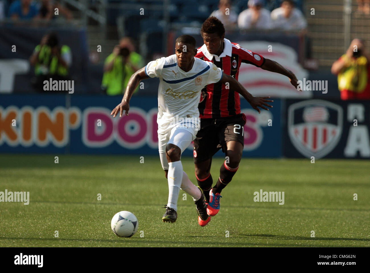 04.08.2012. Massachusetts , USA.  CD Olimpia's Fabio de Souza (4) breaks away from AC Milan's Kevin Constant (21). AC Milan played CD Olimpia at Gillette Stadium in Foxborough, Massachusetts  on August 4, 2012. Stock Photo