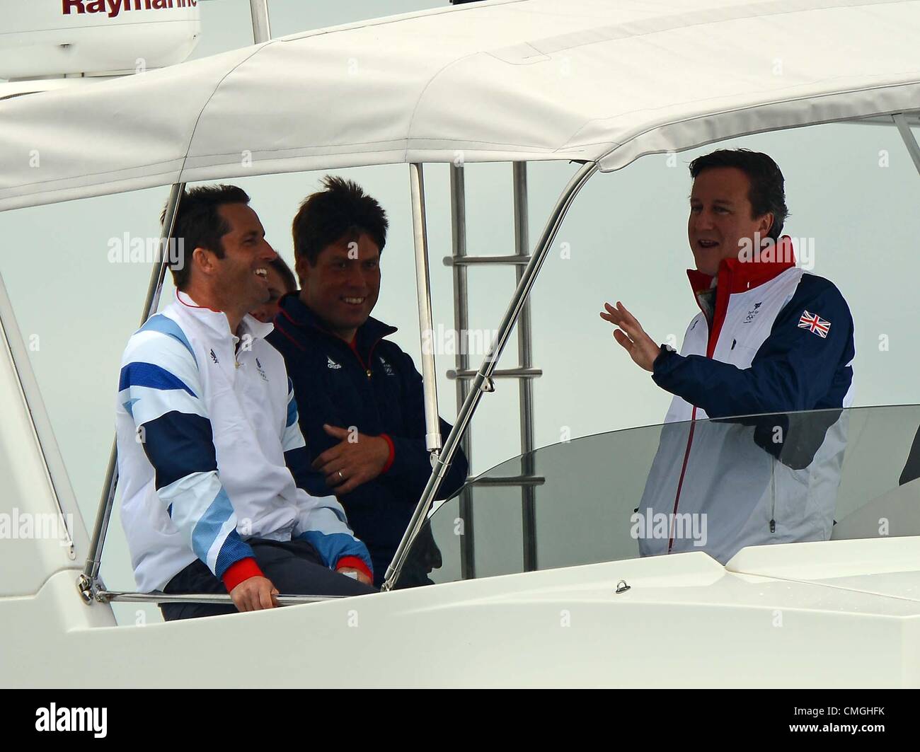 7th Aug 2012. Olympic Sailing, Prime Minister David Cameron visits London 2012 Olympic Games at the Weymouth & Portland Venue, Dorset, Britain, UK. Seen here watching the RS:X with Gold medal winner in the Finn class Ben Ainslie August 7th, 2012 PICTURE: DORSET MEDIA SERVICE Stock Photo