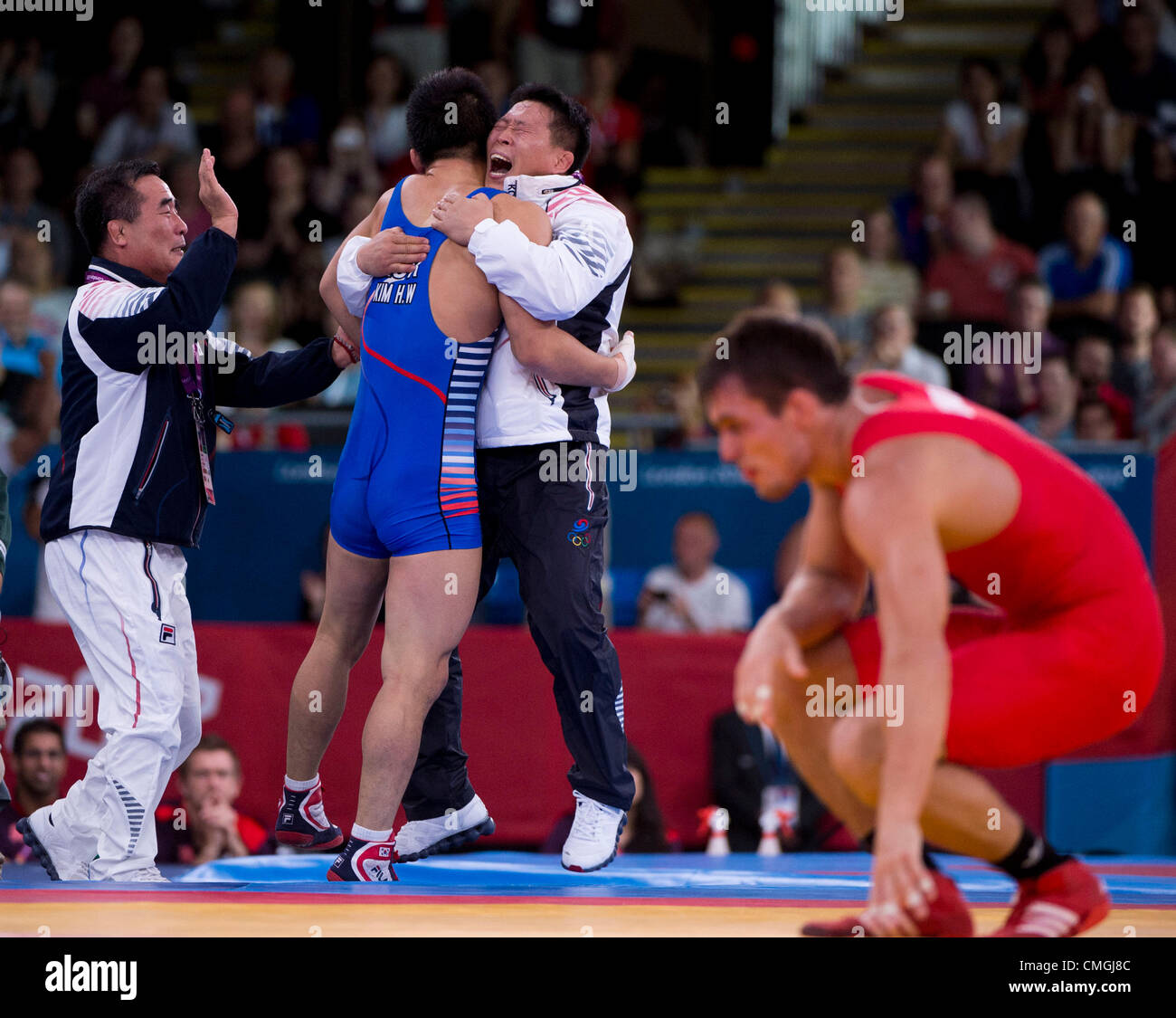 Aug. 7, 2012 - London, England, United Kingdom - HYEONWOO KIM (South Korea) hugs his coach as he advances to the semifinal after beating STEEVEKEM GUENOT (France) in the Wrestling Greco-Roman 66kg competition during the London Olympics 2012 at the ExCel Centre. (Credit Image: © Paul Kitagaki Jr./ZUMAPRESS.com) Stock Photo