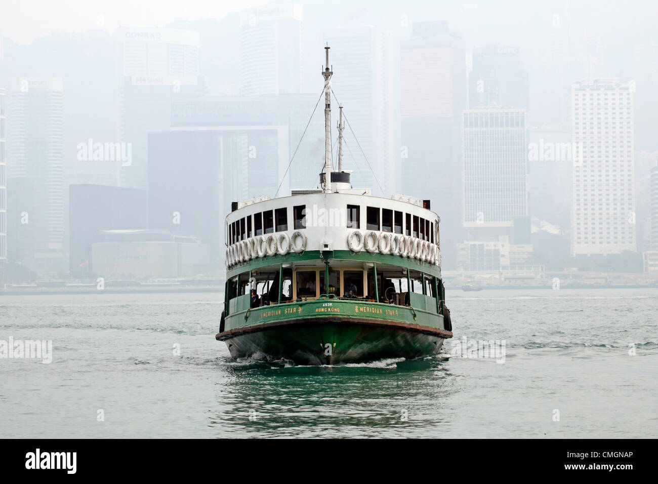 Hong Kong, China. 7th August 2012. The worst smog and air pollution in two years has hit Hong Kong, China. Views across Victoria Harbour and to and from the Peak were obscured amidst warnings for the young and elderly to stay indoors.Coal fired power stations and traffic are a major cause of the environmental problems but also the output of factories in neighboring China. Stock Photo