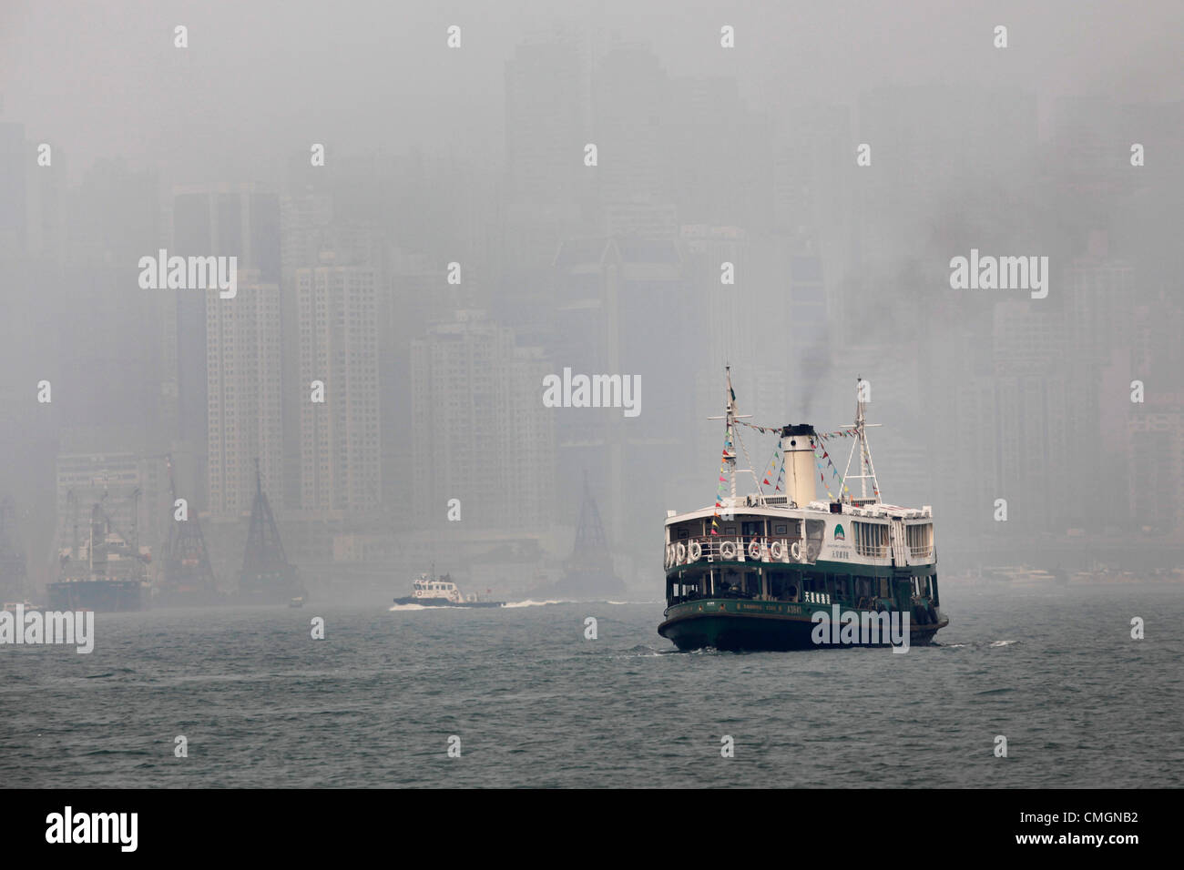 Hong Kong, China. 7th August 2012. The worst smog and air pollution in two years has hit Hong Kong, China. Views across Victoria Harbour and to and from the Peak were obscured amidst warnings for the young and elderly to stay indoors. Coal fired power stations and traffic are a major cause of the environmental problems but also the output of factories in neighbouring China. Stock Photo