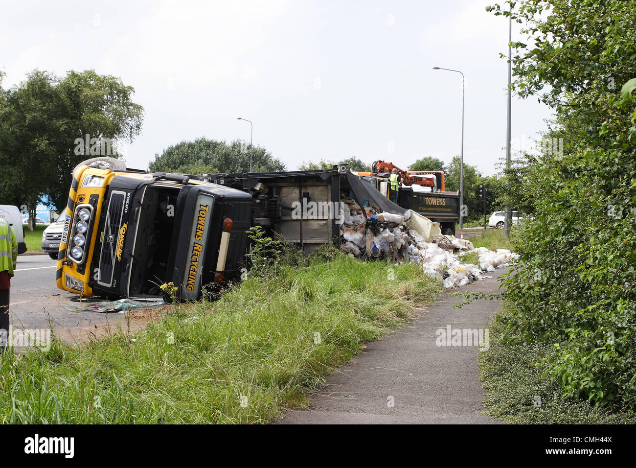 9th Aug 2012. A heavy truck owned by the Weston super Mare based Towens Recycling truned over on its side while travelling on A4174 round the Wick roundabout near the Willy Wicket pub. It was carrying waste for recycling. Credit:  Timothy Large / Alamy Live News Stock Photo