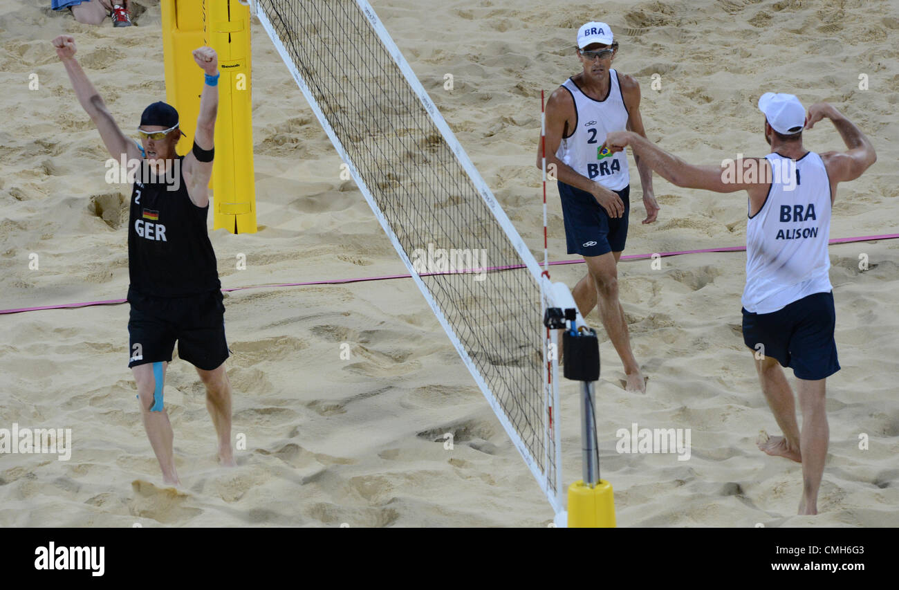 09.08.2012. Horseguards Parade, London, England.  Germany's Jonas Reckermann (L) celebrate next to Brazil's Alison Cerutti (R), and Emanuel Rego (C) during the final match against Cerutti/Rego of Brazil  London 2012 Olympic Games Beach Volleyball competition in Horse Guards Parade, London Stock Photo