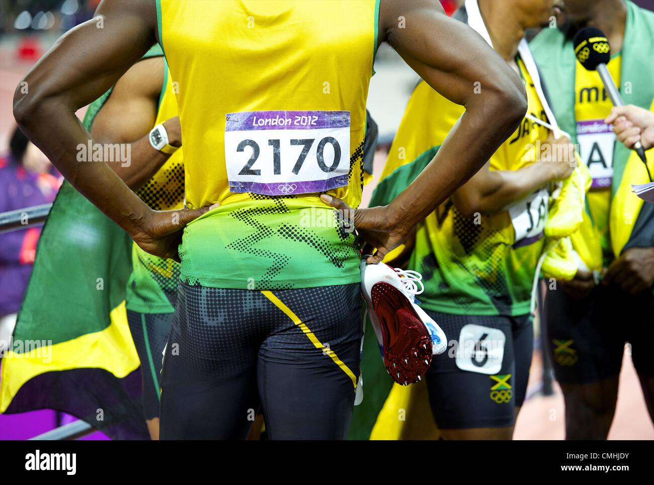 Aug. 11, 2012 - London, England, United Kingdom - USAIN BOLT hold his cleats as the Jamaican 4x100m relay team is interviewed by the media after winning gold and setting a new world record of 36.84 seconds during the 2012 London Summer Olympics. (Credit Image: © Mark Makela/ZUMAPRESS.com) Stock Photo
