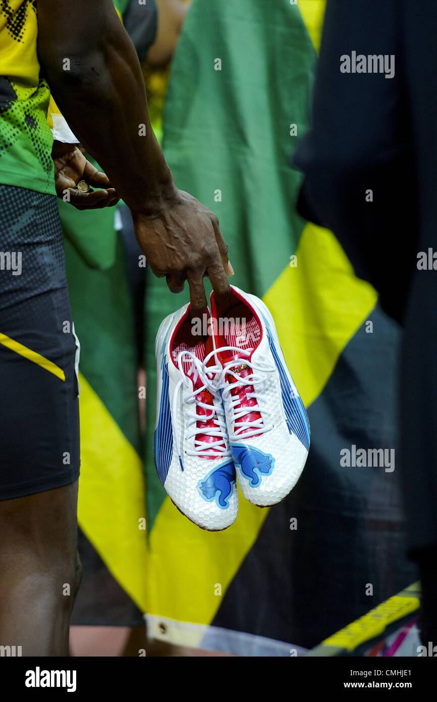 Aug. 11, 2012 - London, England, United Kingdom - USAIN BOLT hold his cleats as the Jamaican 4x100m relay team is interviewed by the media after winning gold and setting a new world record of 36.84 seconds during the 2012 London Summer Olympics. (Credit Image: © Mark Makela/ZUMAPRESS.com) Stock Photo