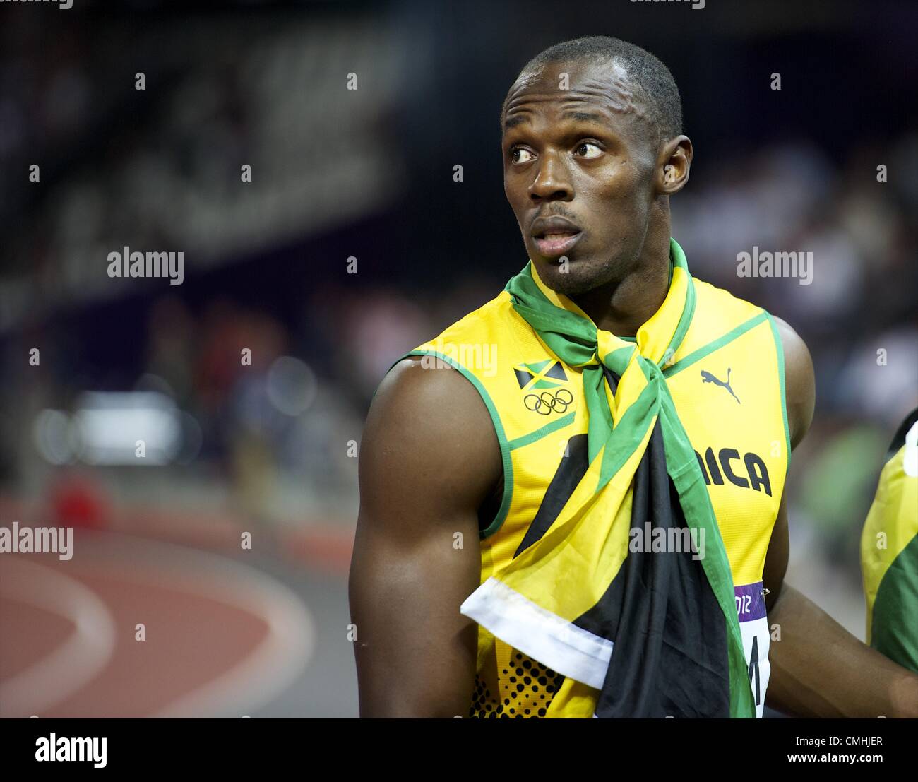 Aug. 11, 2012 - London, England, United Kingdom - USAIN BOLT stares towards the track infield as the Jamaican 4x100m relay team is interviewed by the media after winning gold and setting a new world record of 36.84 seconds during the 2012 London Summer Olympics. (Credit Image: © Mark Makela/ZUMAPRESS.com) Stock Photo
