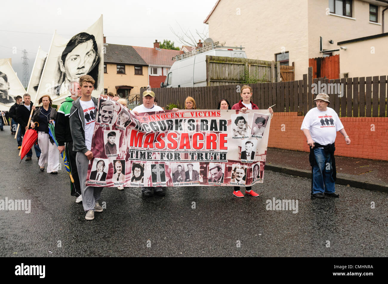 12th August 2012. Belfast.  People carry a banner commemorating the deaths caused when a bomb was placed inside McGurk's bar in 1971 Stock Photo