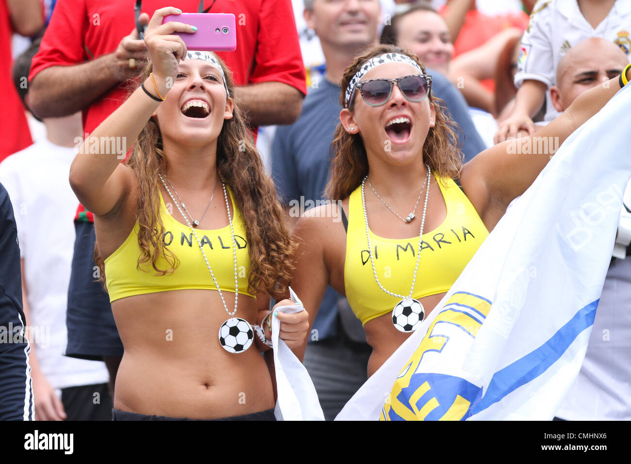 11.08.2012. Philadelphia, USA. Two pretty female Real Madrid fans in bikini  tops painted with Ronaldo and Di Maria cheer on their favorite team during  the World Football Challenge match between Real Madrid