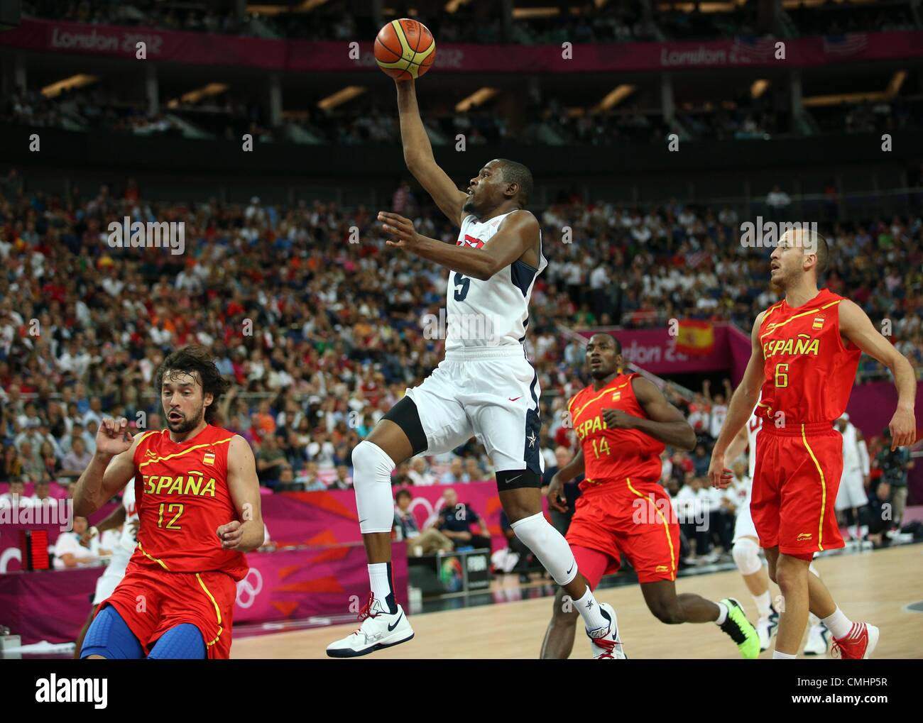 12.08.2012. London, England Kevin Durant of USA (2nd L) with a layup basket  against Sergio Llull (L-R), Serge Ibaka and Sergio Rodriguez of Spain  during basketball final game in North Greenwich Arena