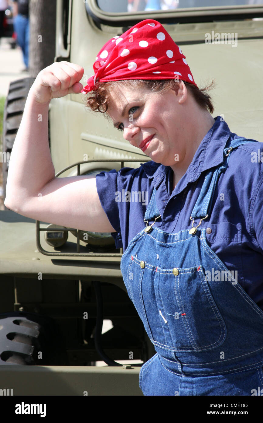 11th Aug 2012. Field of Honor Event at Miller Park Baseball stadium Milwaukee WI USA on August 11, 2012.  Reenactor poses like Rosie the Riveter. WWII veterans were honored at the event with promotion of the Honor Flight that flies veterans to Washington DC to view the WWII memorial. Stock Photo