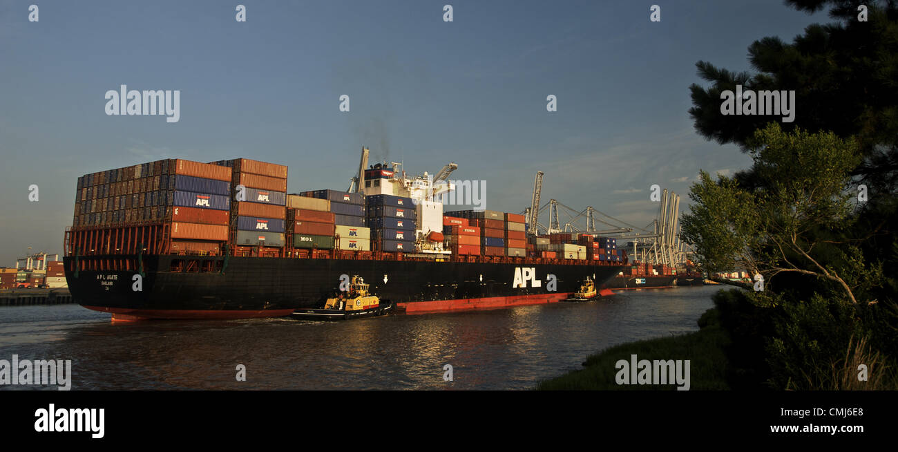 July 30, 2010 - Savannah, Ga, USA - An American President Lines container ship is escorted by a tug boat as it steams up the Savannah River to the Georgia Ports Authority's Port of Savannah in Savannah, Georgia. According to the GPA, the Port of Savannah handled 8.7 percent of the U.S. containerized cargo volume and 12.5 percent of all U.S. containerized exports in FY2011. (Credit Image: © Stephen Morton/ZUMAPRESS.com) Stock Photo